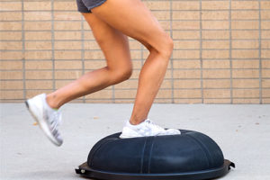 athlete running on bosu ball